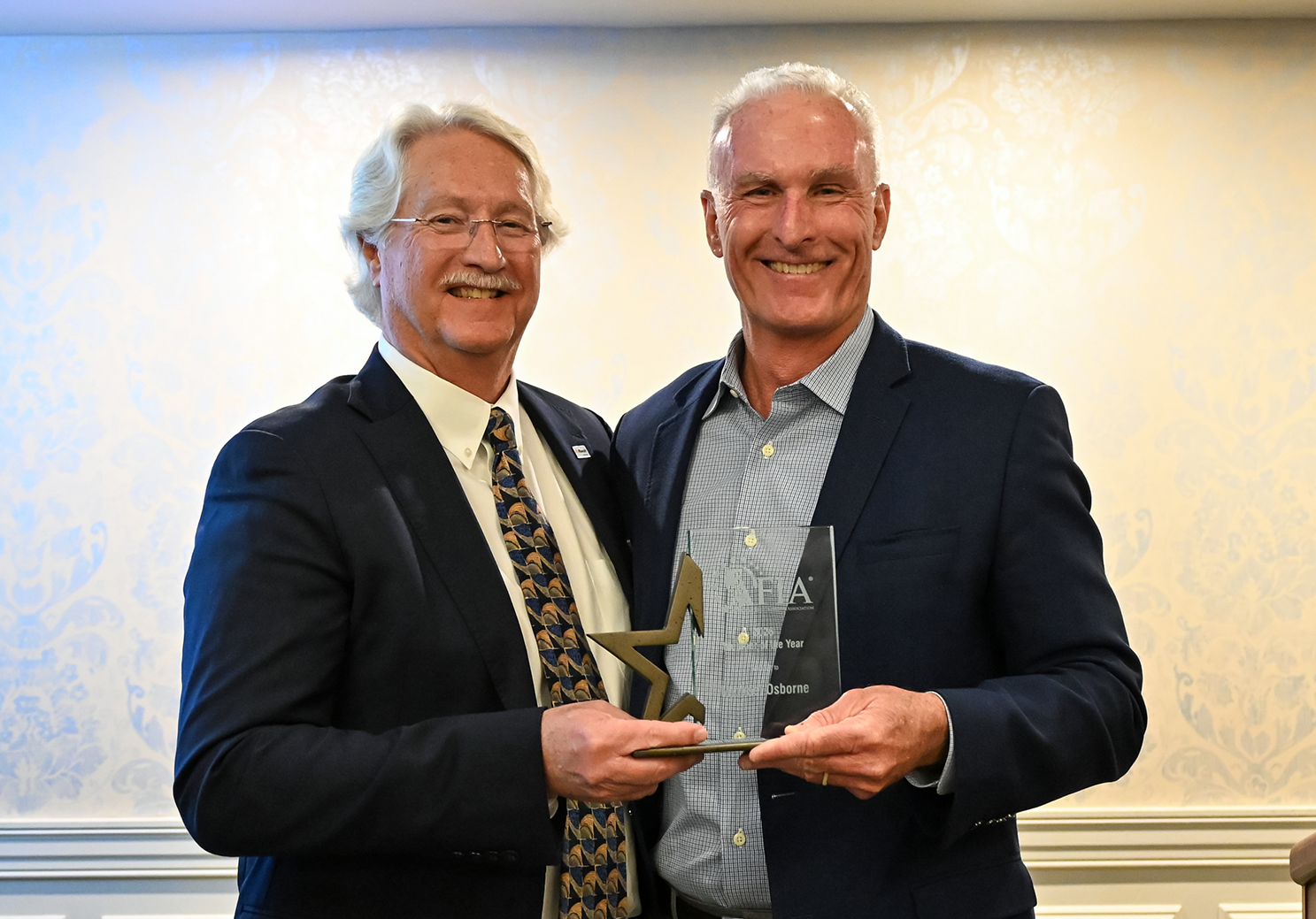 Mike Osborne (left) is presented with the AFIA Member of the Year Award by Dan Meagher, AFIA 2025&ndash;26 Board Chair.