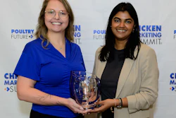 Two women holding an award at the Poultry Marketing Summit event