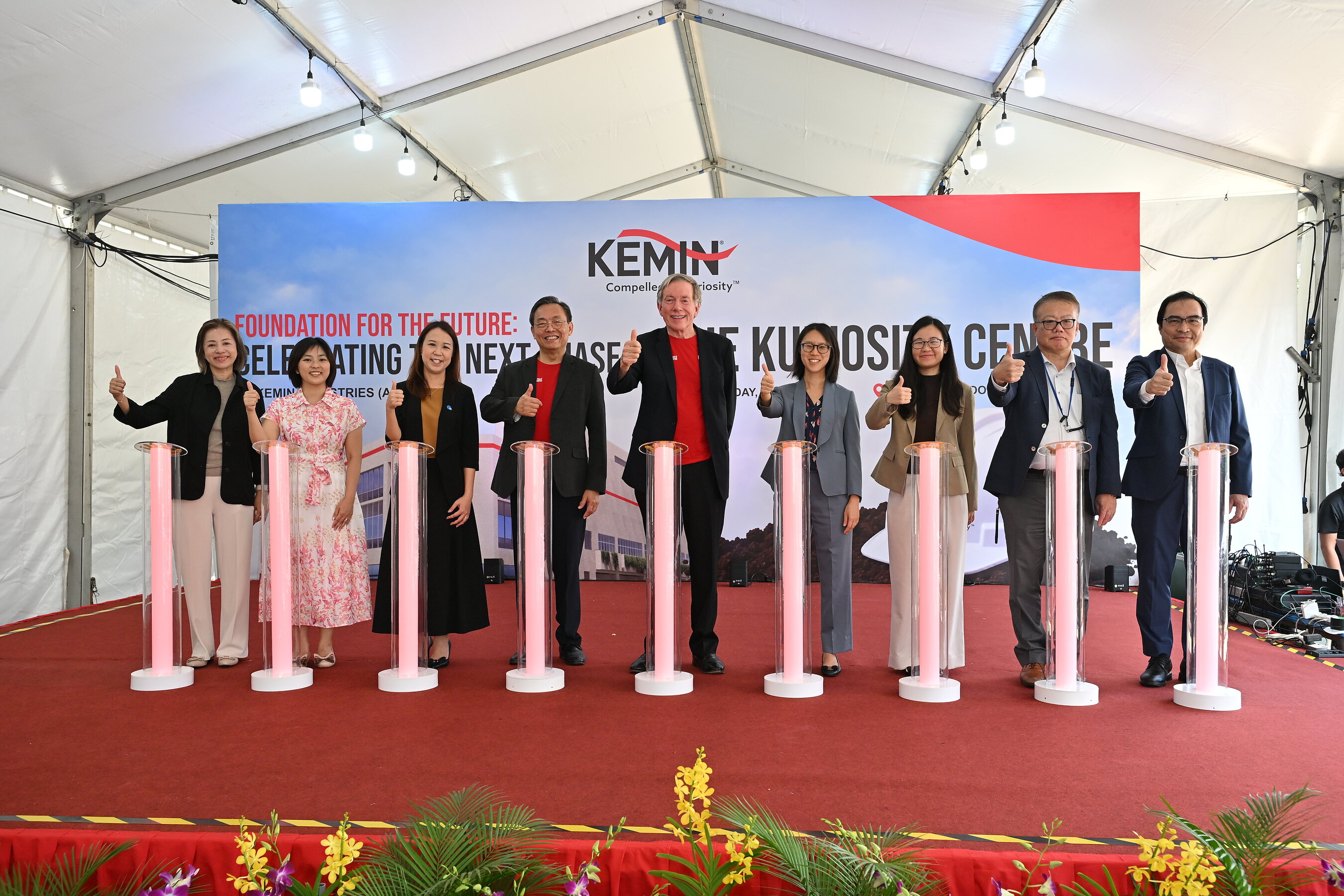 Joyce Wong (JTC Corporation), Hong Yi (JTC Corporation), Christine Wong (JTC Corporation), Dr. Tan Hai Meng (Kemin), Dr. Chris Nelson (Kemin), Kelly Lai (Singapore Economic Development Board), Mei Chun Fong (Singapore Economic Development Board), Naoki Yoneyama (SMCC), and Richard Vergara (SMCC) participate in the foundation-laying ceremony for the Kuriosity Centre.