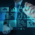 Businessman drawing digital business strategy with analytics charts, network diagrams, and global connectivity icons on blue interface