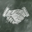 White chalk handshake illustration drawn on a dark green chalkboard background